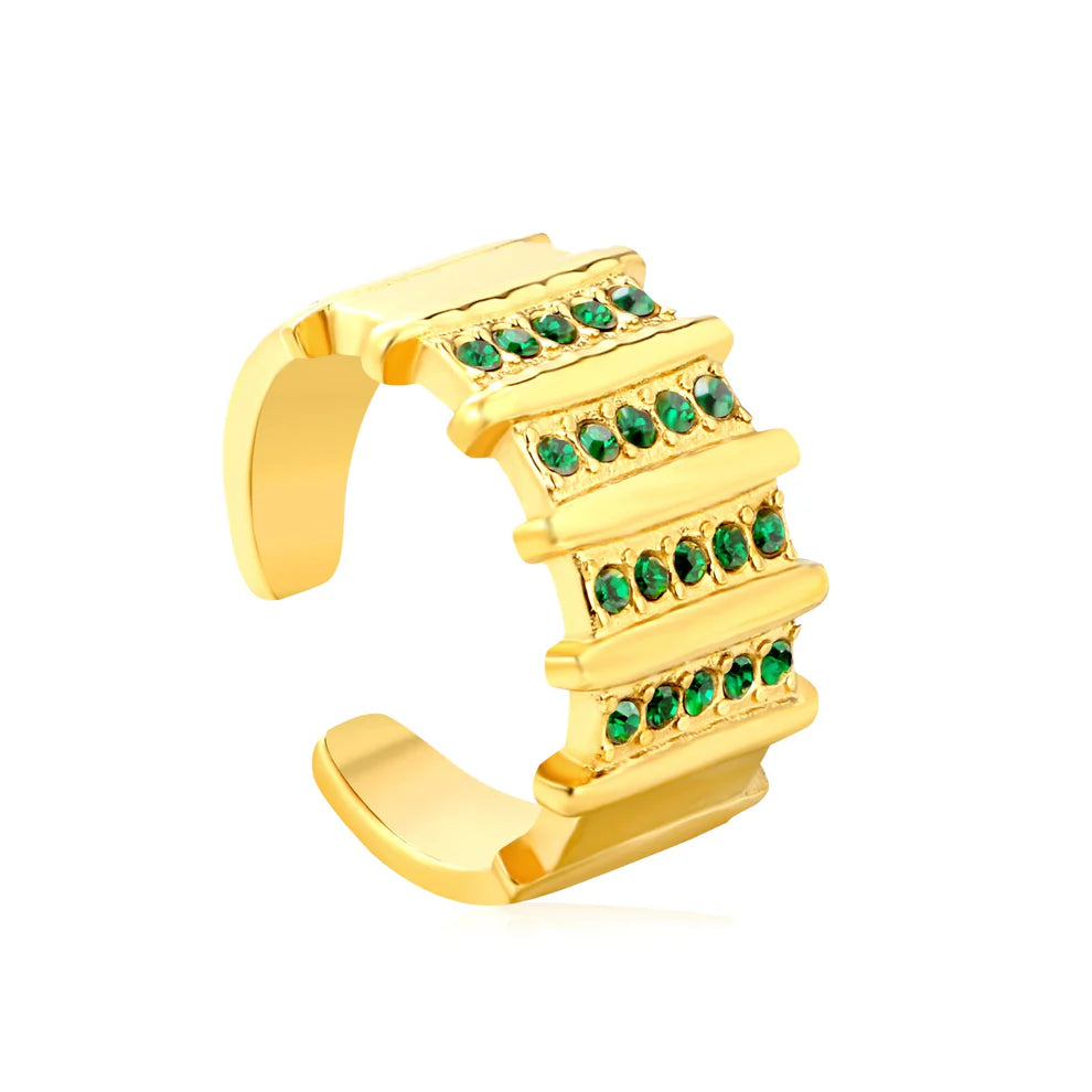Gold ring with green gemstones on a white background
